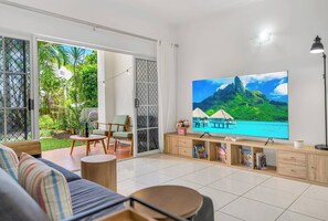 Relax in the spacious living area with direct access to the balcony, offering a perfect blend of comfort and tropical ambience.