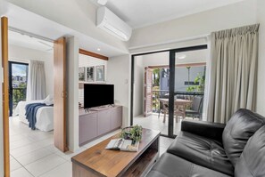 Relax in the air-conditioned living area featuring a comfortable leather lounge that can be converted into a sofa bed upon request.