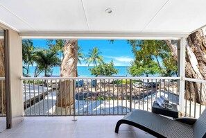 Lounge on the private balcony with comfortable seating, offering breathtaking views of the Coral Sea.
