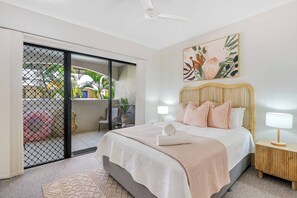 The first bedroom offers a comfortable night's sleep with a queen-sized bed and provides access to the balcony.