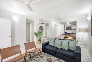 Comfortable sofa seating in the living room encourages cosy nights at home, with a large central TV.
