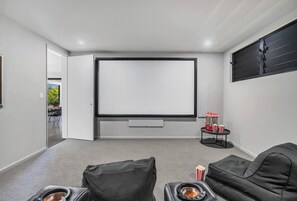 Staying in? Plan a family movie night with a wide screen and movie loungers in the media room.