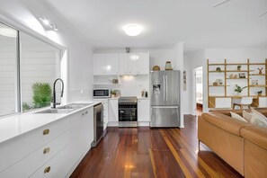 Whip up gourmet meals in the fully-equipped kitchen, complete with premium appliances and ample counter space. 