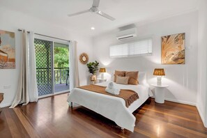 Retreat to the comfort of the first queen bedroom, air-conditioned for your comfort. 