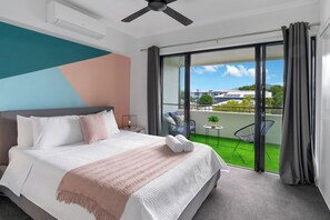 The primary bedroom offers a plush queen-sized bed with high-quality linens, ensuring a restful night's sleep. Enjoy direct access to a private balcony and an ensuite bathroom.