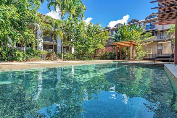 Take a dip in the glistening resort-style swimming pool, surrounded by tropical landscaping. It's the perfect way to cool off after a busy day exploring the city.