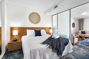 Retreat to the serene bedroom, furnished with a king-sized ensemble bed and large mirrored built-in robes. 
