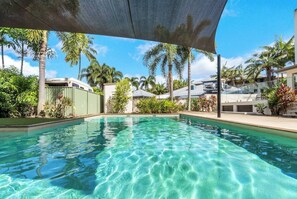 Take a dip in the sparkling shared pool, an inviting spot to cool off and relax under the warm tropical sun. 