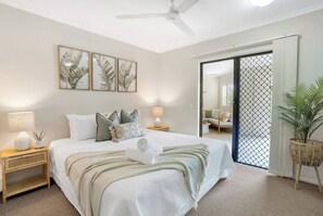 Retreat to the primary bedroom, featuring a king bed, ensuite bathroom, and direct access to the spacious terrace. 