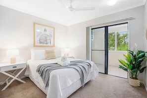 The primary bedroom is a convenient haven with a queen bed, full ensuite bathroom, and access to the balcony. 
