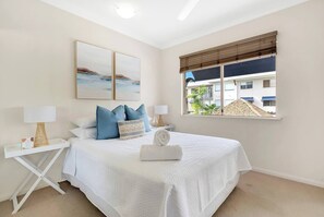 The primary bedroom is a tranquil retreat, featuring a plush queen-sized bed and ample storage. Enjoy the convenience of an attached ensuite for added privacy and comfort.