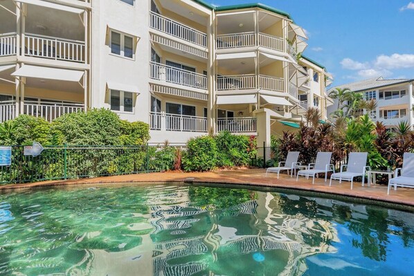 The sparkling shared pool is surrounded by lush tropical gardens, perfect for lounging and taking a refreshing dip to escape the tropical heat. 