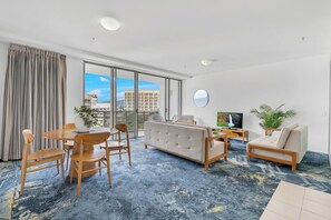 The dining area features a stylish table and chairs, perfect for enjoying meals together.