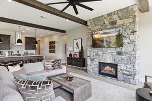 Three Bedroom Vacation Condo Rental Gatlinburg Tennessee The Hig - Spacious and Scenic Living Room with Stone Fireplace, Floor to Ceiling Windows with Smoky Mountain View, Smart TV's and WiFi throughout vacation condo