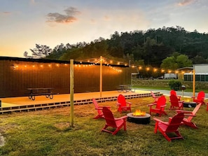 The red chairs gathered around the crackling fire pit, sharing stories and s'mores.