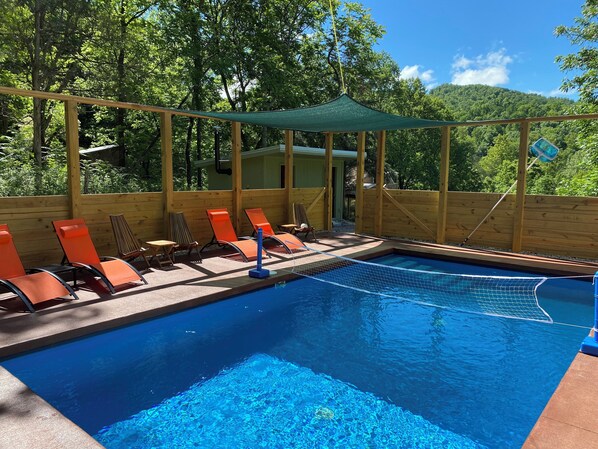 Volleyball and plenty of lounge chairs to enjoy by the pool.