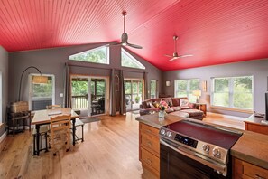 Open living room and kitchen with easy access to the porch and hot tub