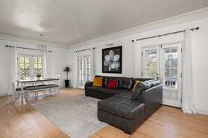 Elegant living and dining area with hardwood floors and modern decor.