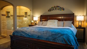 King bed with gorgeous tiled walk-in shower.