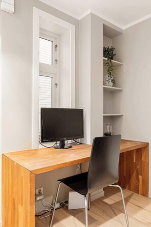 Workdesk with a monitor, fast Wi-Fi, and a tranquil atmosphere for uninterrupted concentration.