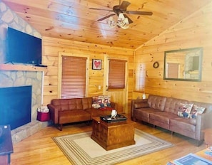 Full living room with a gas fireplace and smart tv.