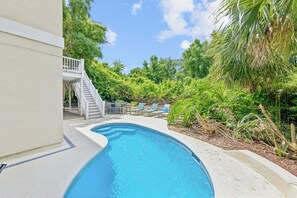 At the basement level, discover a private outdoor deck featuring a kidney-shaped pool and lounging area, essential for your beach getaway.