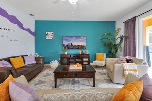 Living room with TV rack and plush couches