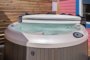 Relax in the bubbly Hot Tub out on the Deck with privacy fencing.