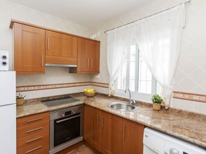 Cabinetry, Countertop, Property, Furniture, Sink, Wood, Interior Design, Drawer, Kitchen, Kitchen Stove