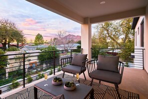(2nd Floor) Covered balcony off the secondary living space with seating and stunning views of Camelback Mountain.