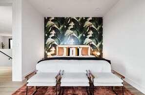 (2nd Floor) 4th Bedroom with King bed, additional seating area, designer decor, and en-suite bathroom.