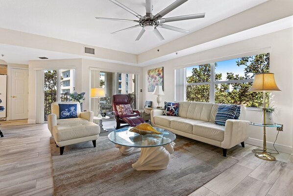 Comfortable leather furnishings and large open windows make this living space a great place to relax!