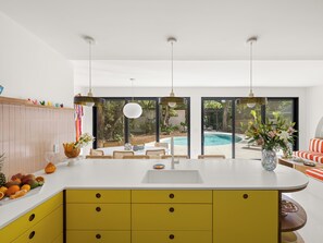 Prepare snacks with pool & jungle views.