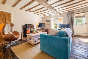 Orchard Cottage, Ringstead: Sitting room with wood burning stove