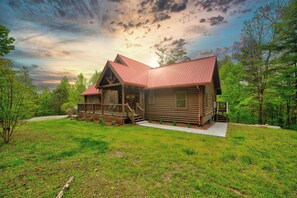 The cabin illuminated at dusk, creating a warm and inviting atmosphere.