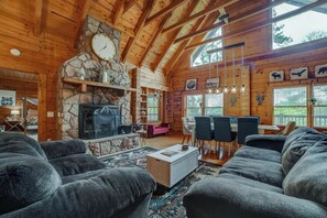 Living area with vaulted ceilings and fireplace perfect for family gatherings.