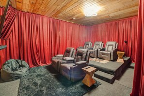 Theater room, complete with plush seating and a warm, inviting atmosphere.