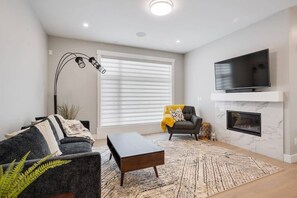 Thoughtfully designed living room with comfort in mind. Heat up by the fireplace and get cozy for night time movies.