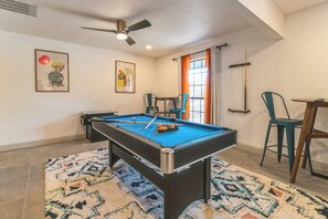 Game room with pool table and ceiling fan