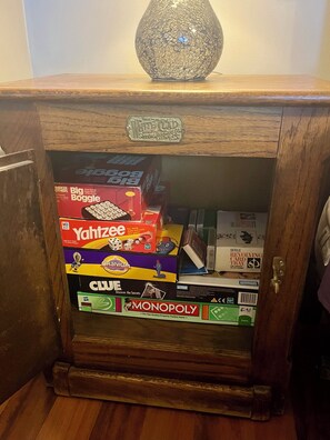 Selection of Family Games Located in Bedroom Nightstand.