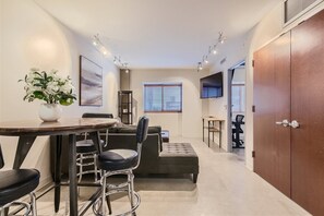 Open floor concept with large L-shaped couch and dinning with barstools.