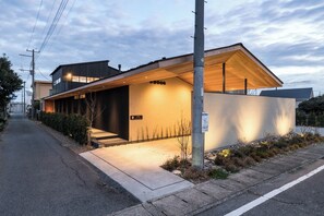 The exterior is lit up at night, giving it a stylish atmosphere.