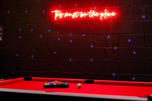 Bring friends for a fun night in this stylish game room with a pool table and neon lights! Perfect for bachelorette parties and groups, enjoy laughter and competition during your Downtown Nashville getaway. Experience Music City luxury in style!