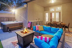 Private patio with al fresco dining, hot tub, and fire pit.