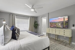 Master bedroom furnished with a flat-screen TV and a private bathroom