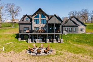 View of home with deck and fit pit
