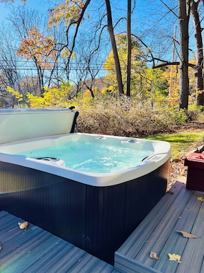 Outdoor hot tub. Relax with 65 jets, LED lighting and body lounger.