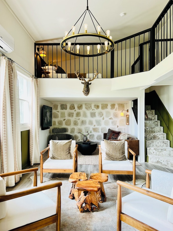 Grand entrance with loft view, lounge, cocktail bar & stone wall