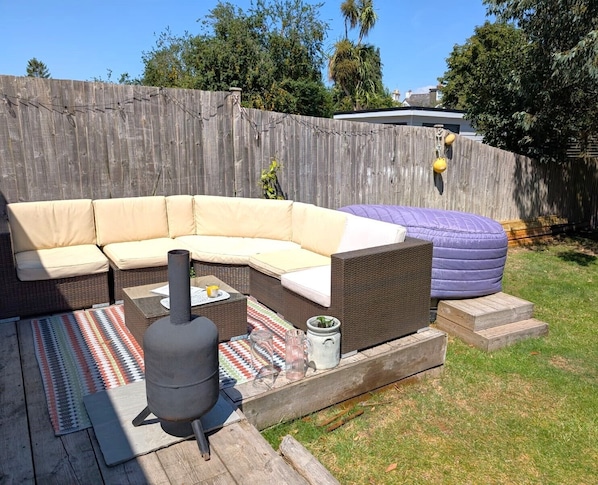 Terrace area in garden with hot tub and fire pit
