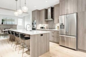 Full-size fully stocked chef's kitchen with high-end Bosch appliances and gas range